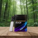 บุหรี่ iFace Double Blast ซองสีดำดีไซน์ล้ำสมัยพร้อมระบบ 2 เม็ดบีบ วางบนโต๊ะไม้ฉากหลังป่าไม้ธรรมชาติ