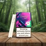 บุหรี่ Davidoff Reach Purple Mint ซองสีม่วงดีไซน์ทันสมัย วางคู่กับมวนบุหรี่บนโต๊ะไม้ ฉากหลังเป็นป่าสีเขียว