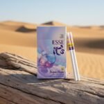 ซองบุหรี่ Esse Bubble Purple สีม่วงพาสเทล ลายฟองสบู่ วางบนท่อนไม้แห้ง ฉากหลังเป็นทะเลทรายและท้องฟ้าใส